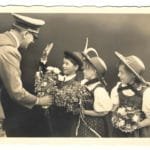 Adolf Hitler greeted by children