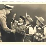 Adolf Hitler greeted by children