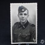 Studioportrait W-SS Soldier wearing Metal Skull on Cap