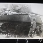 German Press Photograph W-SS in Normandy - 12. SS "HJ" Soldier wearing Camo near Sherman