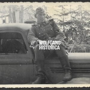 Photograph of Waffen-SS Soldier sitting on car