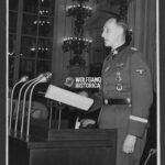 Press Photo: SS-Obergruppenführer Reinhard Heydrich speaking at a Conference